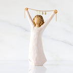 Front view: figure in cream dress holding gold chain above her head with year 2025 on it