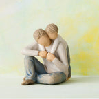 Willow Tree That's my Dad, 4”h hand-painted resin figure of seated man with younger boy leaning over his back, both in neutral clothes, in front of light yellow painting