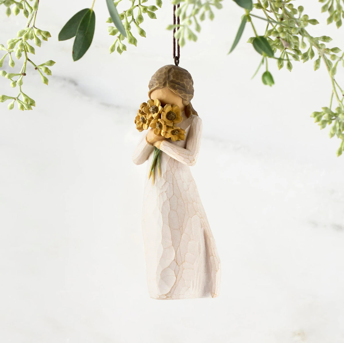 Figure in cream dress, holding large bouquet of yellow sunflowers up to face. Hook and loop affixed to figure's head