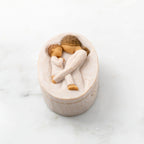 Willow Tree Tenderness Keepsake Box, 3.4" oval x 2.4" W x 1.5" D hand-painted resin box with removable lid. Lid has bas-relief carving of woman holding toddler, touching foreheads, inside of box has sentiment