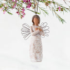 Front: Angel Ornament with wire wings, darker skin, arms crossed over gold heart, dress carved with symbols of remembrance