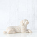Small white dog figurine laying down
