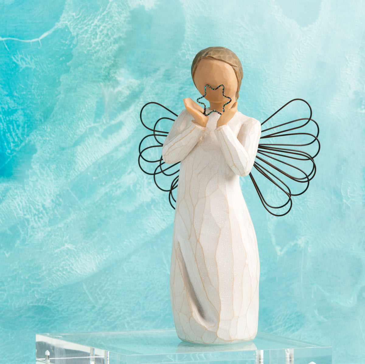 Willow Tree Bright Star, 6”h hand-painted standing resin angel figure in cream dress with wire wings, holding glittered wire star, in front of aqua painting