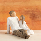 Willow Tree Father and Daughter, 5”h hand-painted resin figure of seated man dressed in neutral colors, legs outstretched, daughter in cream dress by his side, in front of sienna painting