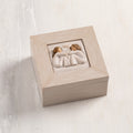 Cream wood box with hinged lid. Inset bas-relief plaque of two seated girls, facing each other.