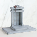 Grey barn standing up on stand with brown star on it
