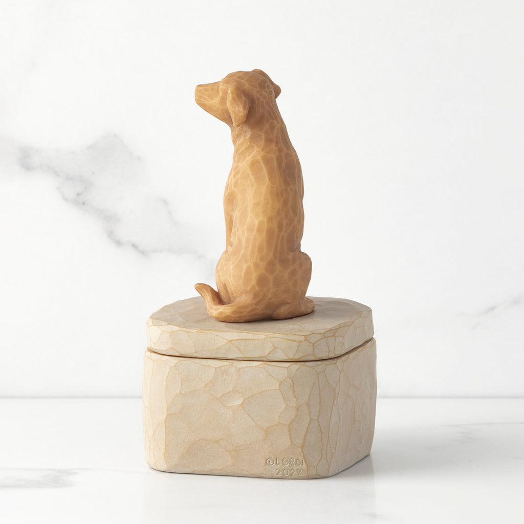 Back view: putty-colored square resin box with lid, 3-D figure of golden color dog atop lid