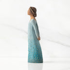 Left profile: Darker-skin figure, arms clasped behind back, hair and deep blue ombré garment dotted with gold leaf