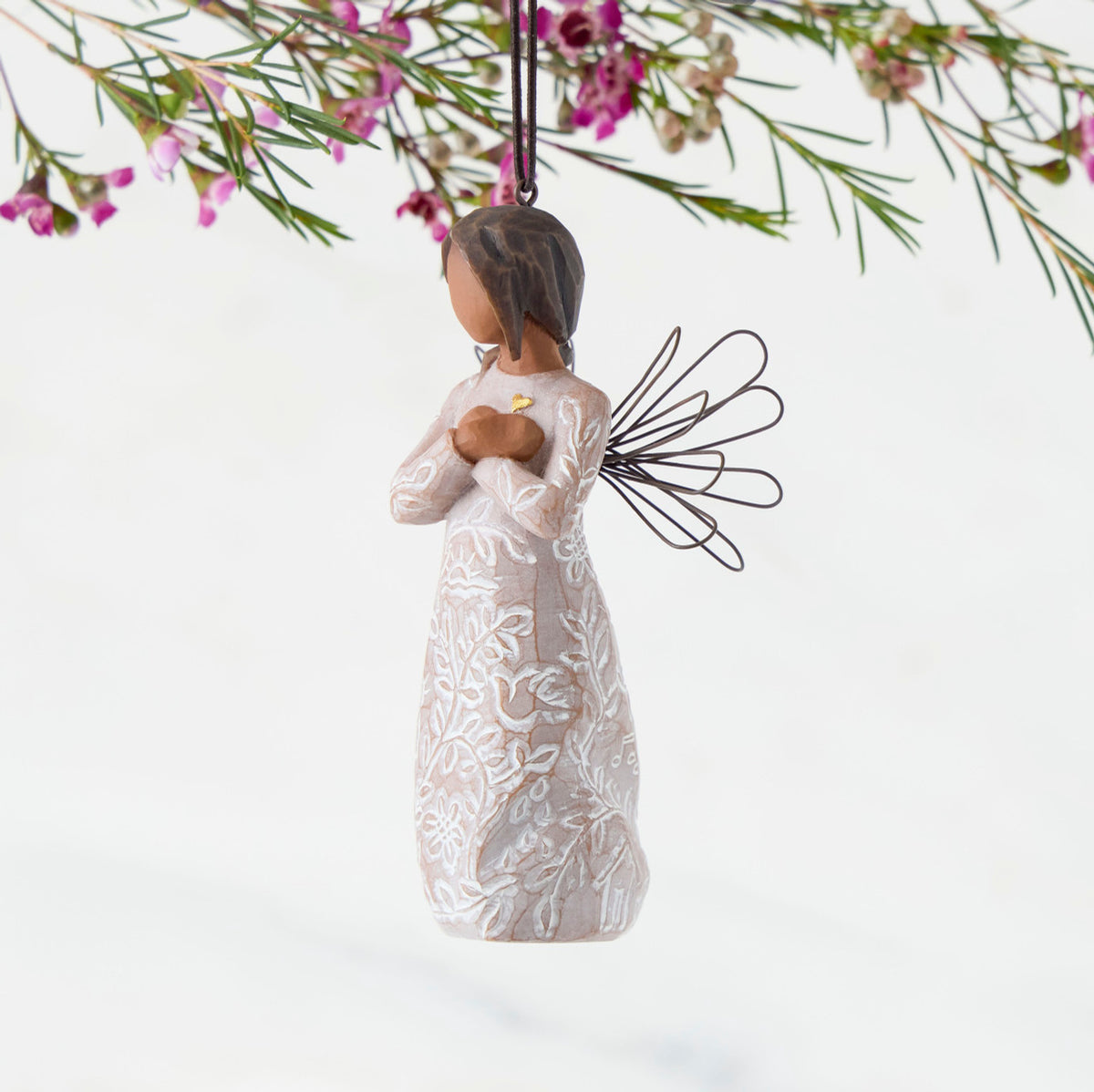 Left Side: Angel Ornament with wire wings, darker skin, dress carved with symbols of remembrance