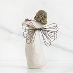 Back view of brunette angel figurine with brown wire wings standing up