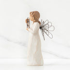 Right side view of angel with tied back brown hair, holding up a circular wire sign that says "thank you"