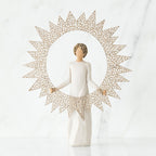 Brunette girl figurine in white dress standing facing forward holding large sun figurine