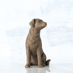 Dark grey sitting down dog figurine looking to the side