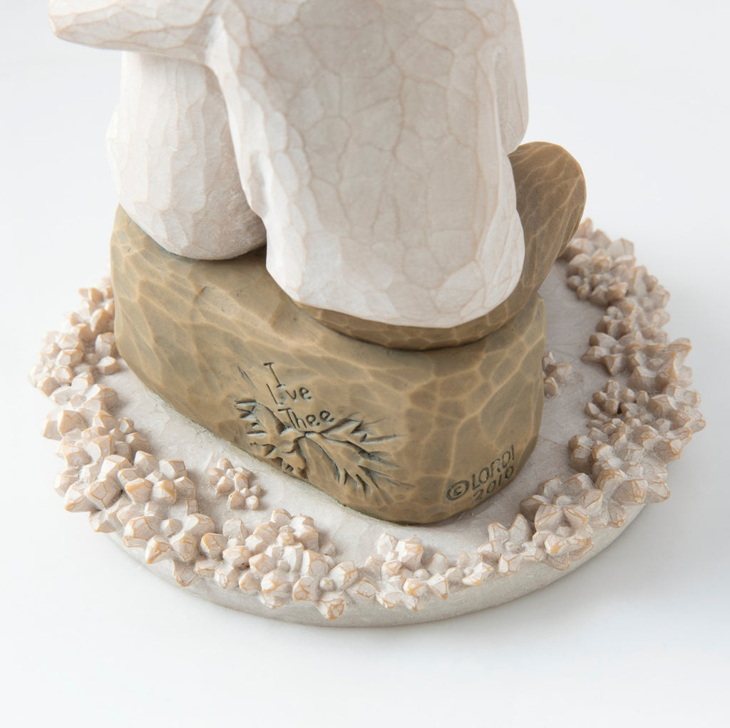 Close view of round white plaque with golden rock on top