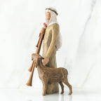 Wiseman figurine in brown next to sheep figurine