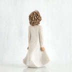 Back view of curly hair girl figurine in white dress standing up