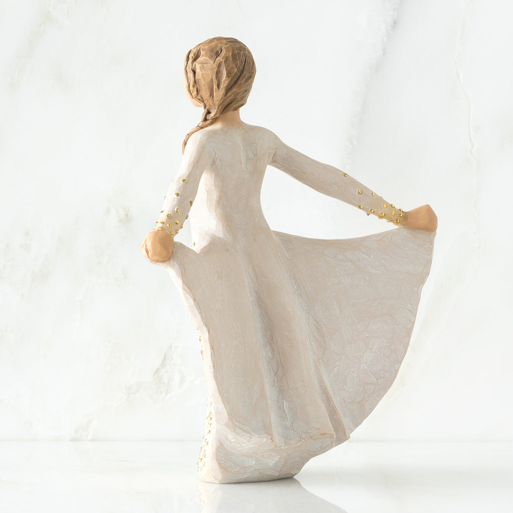 Back view of brunette woman in white dress holding up her dress