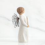 Left side view of angel with short, light brown hair holding a metallic wreath of hearts with both hands