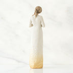 Back view of brunette woman wearing white dress with gold bottom