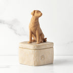 Putty-colored square resin box, 3-D figure of golden dog on lid, paw print carving on side of box