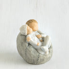 Close view of grey bean bag with two siblings hugging one another on it