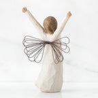 Back view of brunette angel figurine in white dress with brown wire wings