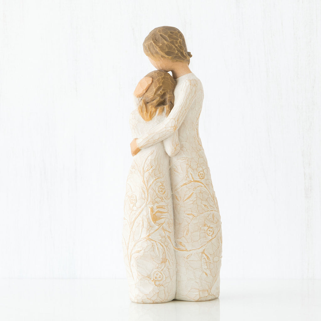 Side view of two brunette girls in white dresses hugging another