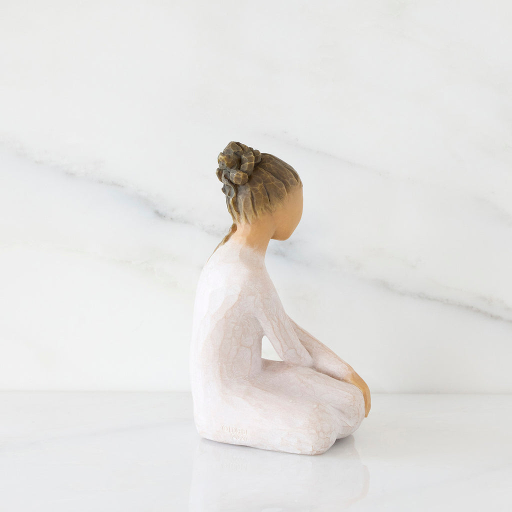 Right-facing view: seated figure in cream dress with crossed arms