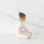 Right-facing view: seated figure in cream dress with crossed arms
