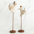 Set of two angel figurines in white dresses danging on wooden stands