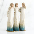 Three brunette woman figurines in white dresses blue bottoms facing forward with arms around each other