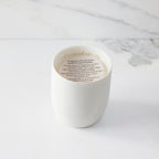Top view of candle with vellum insert sheet with burning instructions