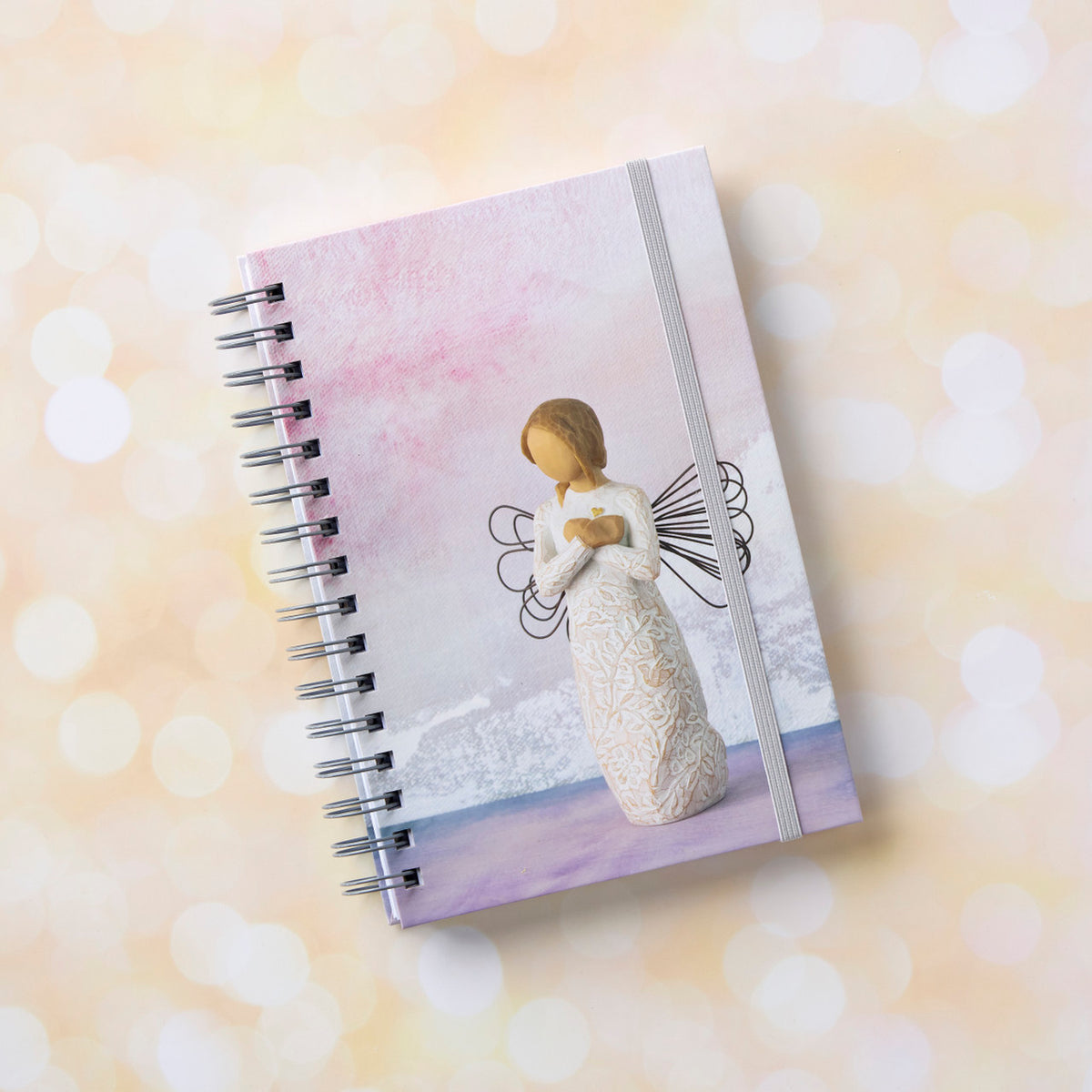 Willow Tree Remembrance Notebook, 6.5"w x 8.5"h, hard-cover, spiral-bound, 240 lined pages, front cover features Remembrance figure on background of purple-blue painting