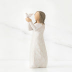 Faceless woman figurine in white dress holding up white bird in her arms