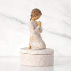 Right side: cream oval resin box, 3-D figure in prayer pose atop lid, in cream dress carved with birds and flowers