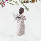 Right Side: Angel Ornament with wire wings, darker skin, dress carved with symbols of remembrance