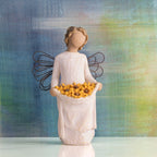 Willow Tree Sunshine, 5.5”h hand-painted standing resin angel with darker skin and hair, cream dress and wire wings, holding up skirt full of Black-Eyed Susans, in front of deep blue painting