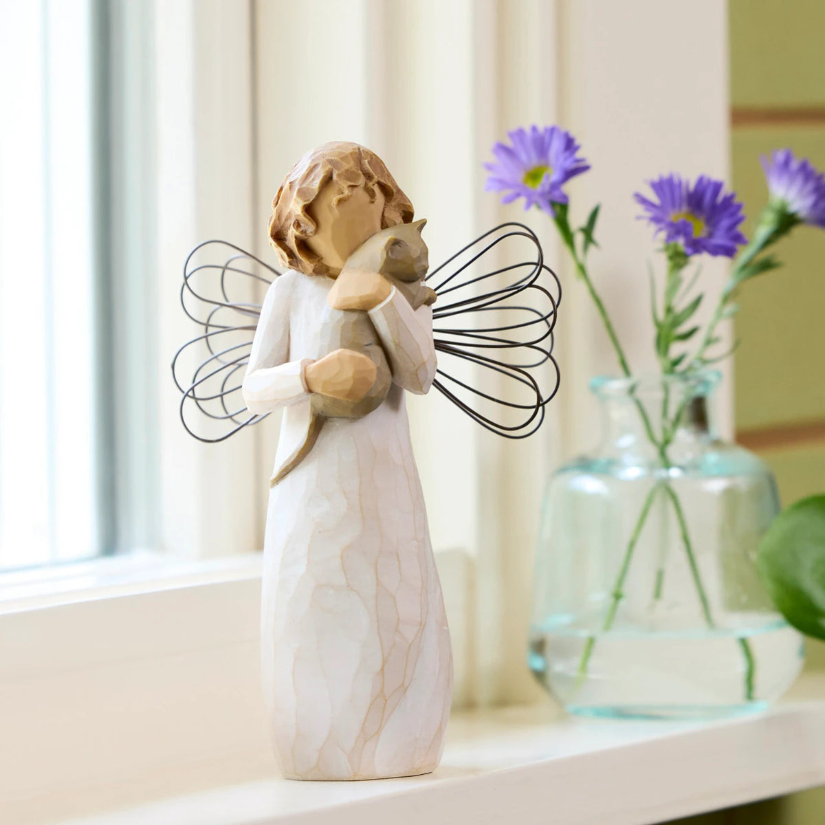 Willow Tree With affection, 5”h hand-painted standing resin angel figure, in cream dress with wire wings, holding gray cat, on sunny window ledge