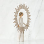 Brunette girl figurine in white dress holding up rose gold sun figurine