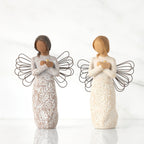 Lighter & Darker skin versions of angel with wire wings, arms crossed over gold heart, carved with symbols of remembrance