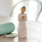 Willow Tree Nurture, 5.5”h hand-painted standing resin figure in cream dress, holding baby bluebird, on table near window