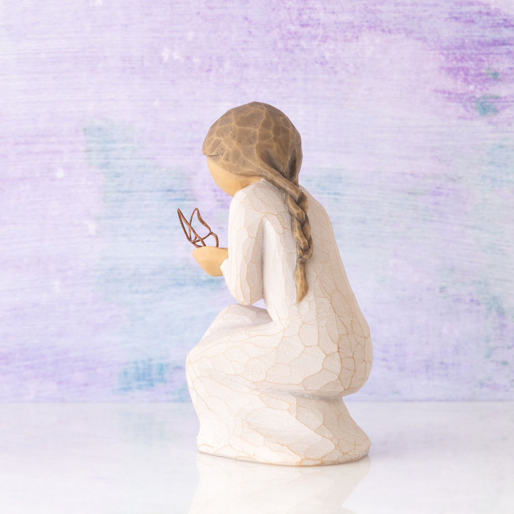 Willow Tree Quiet Wonder, 3.5”h hand-painted resin figure, kneeling in cream dress with gold leaf wire butterfly on extended hands, in front of lavender painting