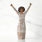 Front view of figure with natural hairstyle, arms raised overhead, dress etched with African textile patterns
