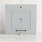 Back of dove gray wood frame with keyhole hanger and built-in kickstand