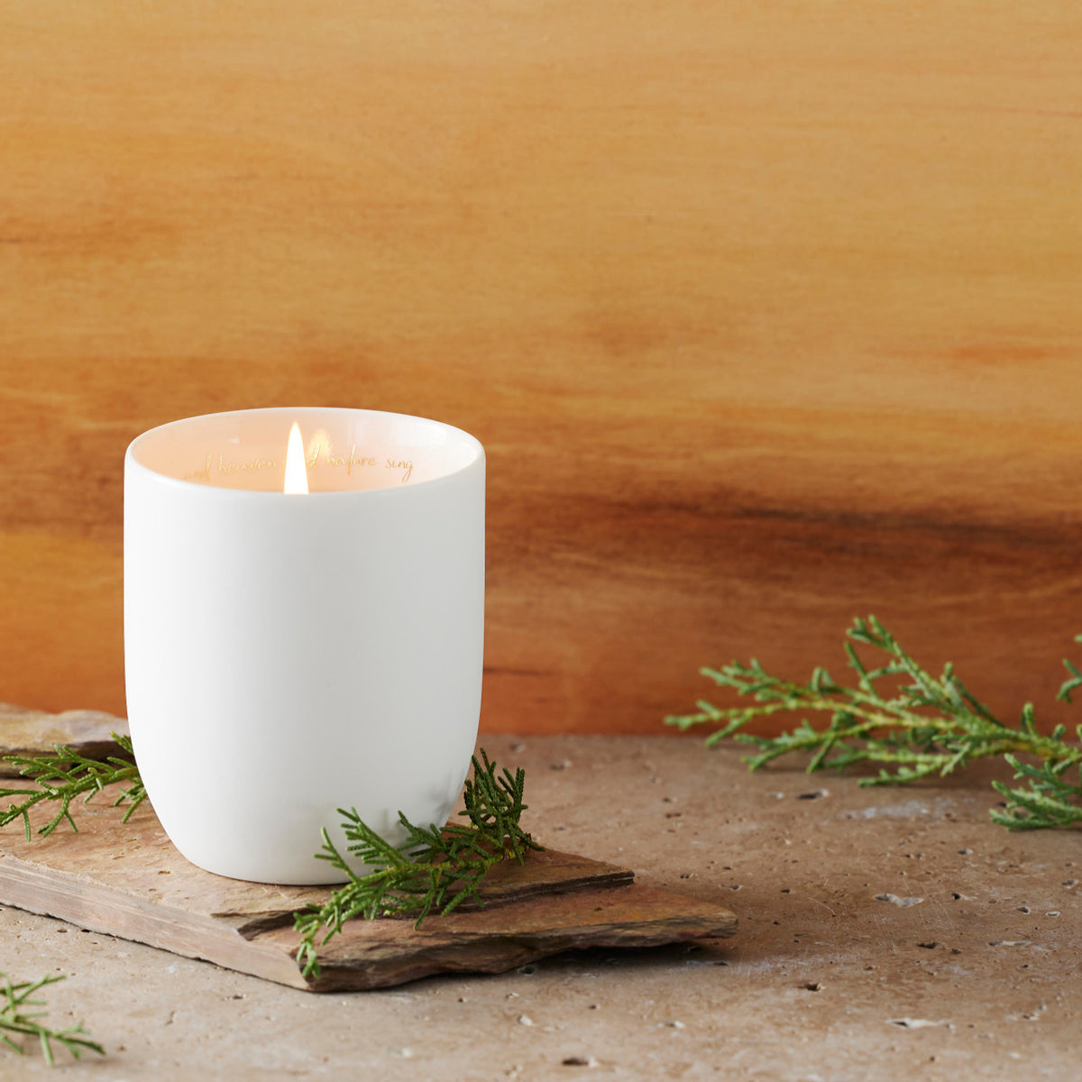 Filled scented candle with unglazed off-white tapered cylinder vessel, sentiment written in gold inside rim, plant-based wax blend, all-cotton wick.