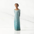 Facing front: Darker-skin figure, arms clasped behind back, hair and deep blue ombré garment dotted with gold leaf