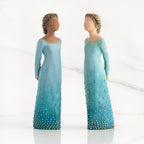 Front view of both lighter and darker-skin figures, arms clasped behind backs, hair and deep blue ombré garments dotted with gold leaf.